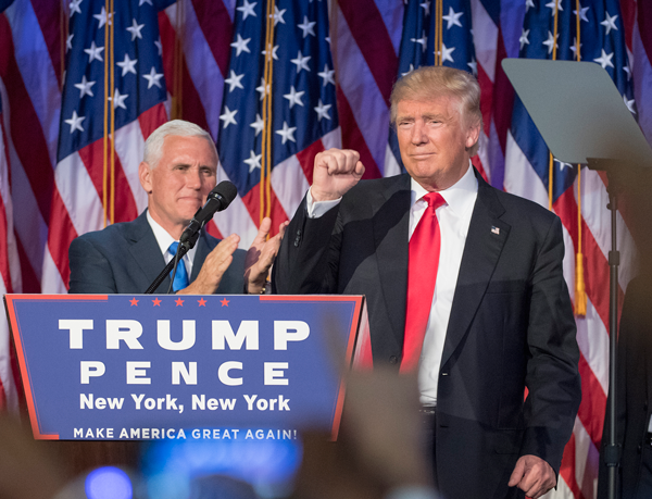 J. Conrad Williams Jr./Newsday/TNS President-elect Donald Trump pumps his fist, with running mate Mike Pence standing by, following his victory speech. Photo by J. Conrad Williams Jr./Newsday via TNS