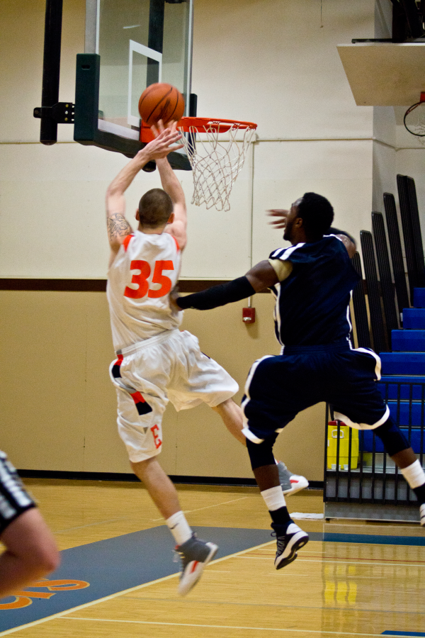 Mike Love, left, adds to the lead in Eastfield’s first game against Northwood, which the Harvesters won by 47 points.