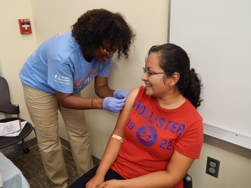 Volunteer preps attendees’s arm for a flu vaccination during the Harvest Fest Health Fair Oct. 5.