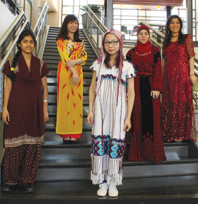 Representing cultural fashion left to right is Angelin Jameson representing India, international student Lily Nguyen representing Vietnam, Paw Day for Thailand, Fatn Fuad wearing traditional garb from Palestine, and Leyla Mohamadyar shows off an Iranian dress. Photo by Ana Gallegos/The Et Cetera.