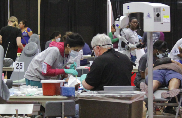 Dentists with the Texas Dental Association’s Mission of Mercy work on patients during a pro bono clinic April 10 and 11 at Eastfield. Photo by Jonathan Wences/The Et Cetera.