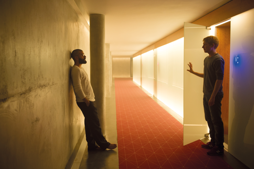 Nathan (Oscar Isaac) and Caleb (Domhall Gleeson) in a scene
from Ex Machina. Photo Courtesy A24 Productions.