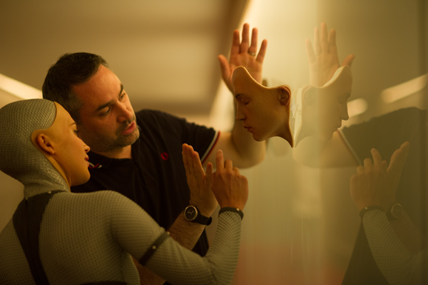 "Ex Machina" director Alex Garland helps Alicia Vikander, who plays the cyborg Ava, prepare for a scene. Photo Courtesy A24 Productions.