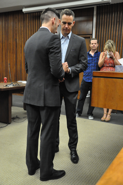 David Telfer, left, and Sean Williamson exchange rings as they are married Friday at the George Allen Sr. Courts Building in Dallas. (Photo by Ana Gallegos/The Et Cetera)