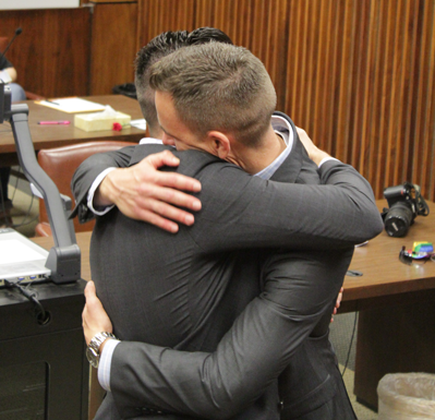 David Telfer, left, and Sean Williamson embrace after their marriage Friday at the George Allen Sr. Courts Building in Dallas. (Photo by James Hartley/The Et Cetera) 