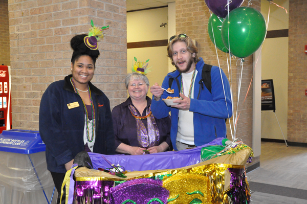 Judy Schwartz, former director of Student Life, celebrates Mardi Gras in February with clubs coordinator Unswella Ankton and student Michael Heggie. Photo by Ana Gallegos/The EtCetera