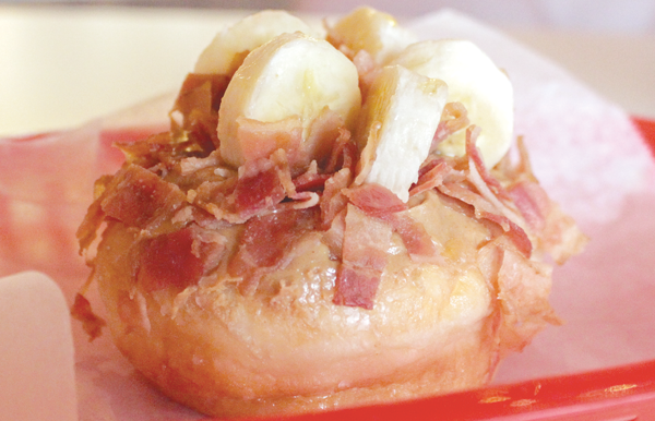 Hypnotic Donuts’ “Evil Elvis” takes a classic glazed donut and tops it with bacon and banana slices. PHOTO BY GUILLERMO MARTINEZ/THE ET CETERA