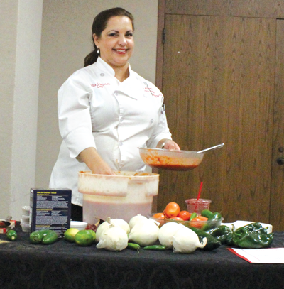 Chef Lydia Gonzalez of the Addison restaurant Savorista prepares
fresh salsa during a cooking demonstration Oct. 21.
PHOTO BY GUILLERMO MARTINEZ/THE ET CETERA