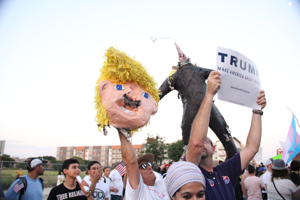 James Hartley/The Et Cetera As it gets later, Trump and anti-Trump demonstrators mix in the streets and get into shouting matches, holding up signs and one man even tearing the head off of a Trump pinnate to help make his point. 