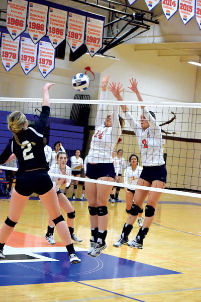 Faith Faulkner and Alyssa Tomlin go up to block during the Oct. 10 win over Mountain View. The Harvesters defeated the Lions 3-0 (25-9, 25-15, 25-18) Photo by Andrew Gonzales/The Et Cetera