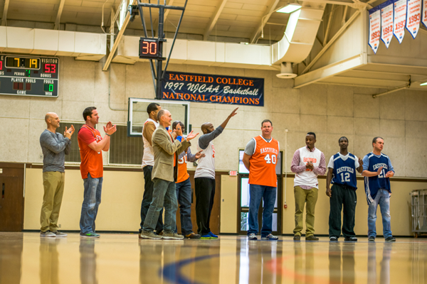 The players and coaches stand out on center court, thanking everyone present. The commemorative banner recognizing their national title hangs inside the gym. Photo by Andrew Gonzales.