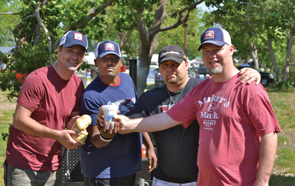 Oslynn Williams (second from left), a digital media professor and competitive barbecue chef, poses with his team, the Capps. Photo courtesy of Oslynn Williams.