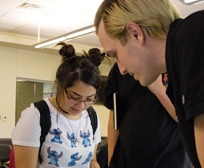 Will Heron shows his prints to Jasmine Hernandez. Photo by David Sanchez.