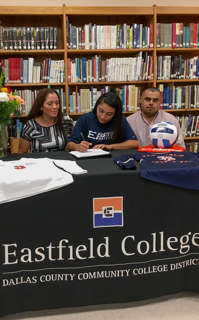 Maura Munoz, right, signs her letter of intent to play volleyball at Eastfield as her mother, Veronica, watches on.