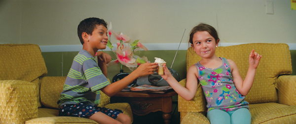 Scooty, left, and Moonee, played by Christopher Rivera and Brooklynn Prince, share an ice cream during a scene in “The Florida Project.”  Courtesy of A24