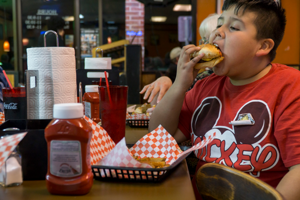 Zachary Goings, 9, digs into a burger. He has been
visiting Burger Style Cafe his entire life. Photo by Yesenia Alvarado/The Et Cetera
