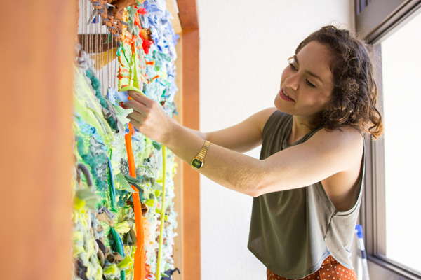 Westrup makes final touches to the Land Loom, a part of the Literary & Fine Arts Festival. Photo by Yesenia Alvarado/The Et Cetera