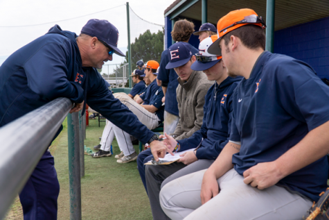 Coach Michael Martin looks over pitching records from practice with some of the team’s pitchers. Throwing more strikes is one of Martin’s biggest focuses for the team going into conference play. Photo by Yesenia Alvarado/The Et Cetera