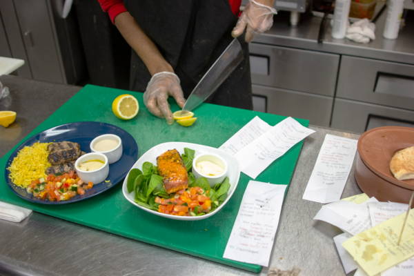 A plate of kafta with rice and Maya’s salad can be bought for $10.99 and a bowl with salmon and harissa butter is on the menu for $13.50.  Photo by Yesenia Alvarado/The Et Cetera