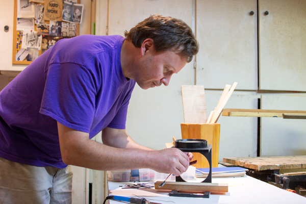 Yesenia Alvarado/The Et cetera
Computer programming professor David Kirk works on a wooden racecar in his dad’s home workshop. Photo by Yesenia Alvarado/The Et Cetera