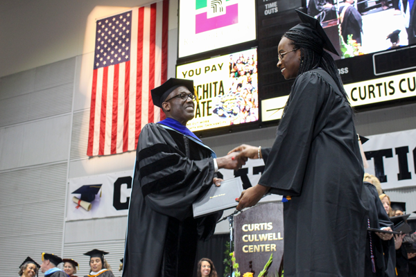 President Eddie Tealer shakes hands with a graduate at the 2019 graduation at the Curtis Culwell Center. Plans have been announced to hold in-person graduations for the class of 2021. Et Cetera File Photo