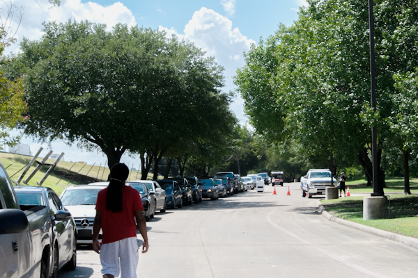 A line of people waits in their cars at the Mesquite Reception Center on Aug. 27 after evacuating areas that were going to be hit by Hurricane Laura. Photo by Chantilette Franklin/The Et Cetera