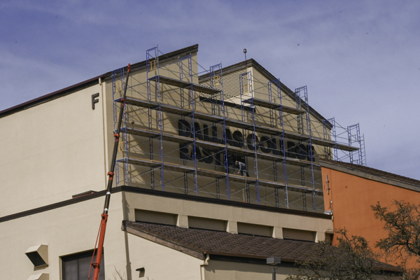 A worker puts up the sign that will replace the Eastfield College lettering on the F building on March 8. Photo by Chantilette Franklin/The Et Cetera