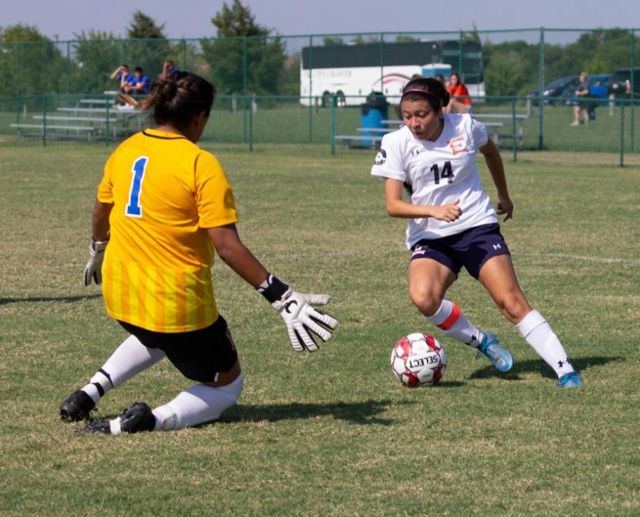 Laisha Garcia dribbles the ball beside the goalie for the Jarvis Christian College soccer team.
