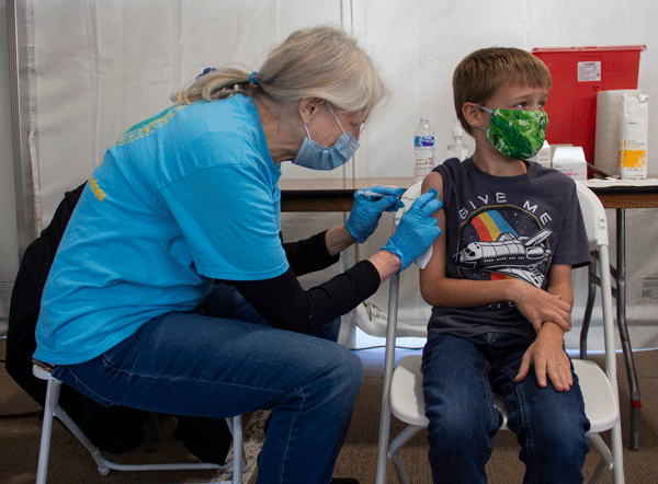 A boy gets his first dose of the Pfizer vaccine at the Eastfield site on Nov. 5.