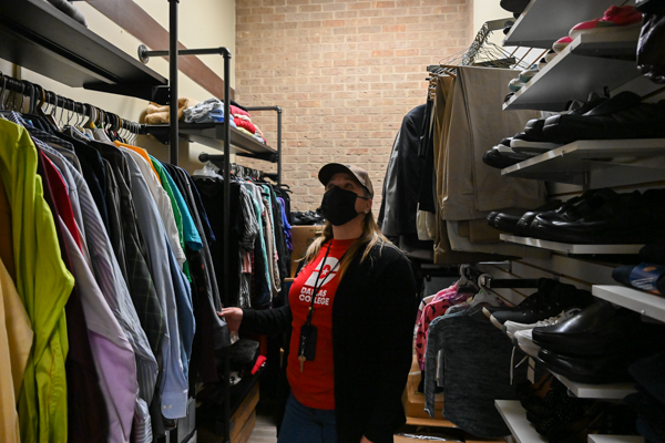 Wendy Garner places clothes inside the Honeycomb Cupboard Pantry in C104A. Photo by Rory Moore/The Et Cetera.