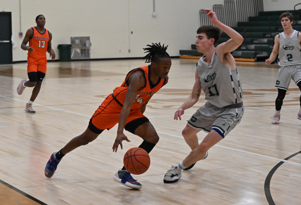 Jamari Robertson dribbles the ball while trying to evade a Brookhaven player on Feb. 9. Photo by Rory Moore/The Et Cetera