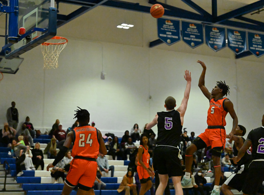 Anthony Hunter shoots for the score with assistance from Jamari Robertson. Photo by Rory Moore/The Et Cetera