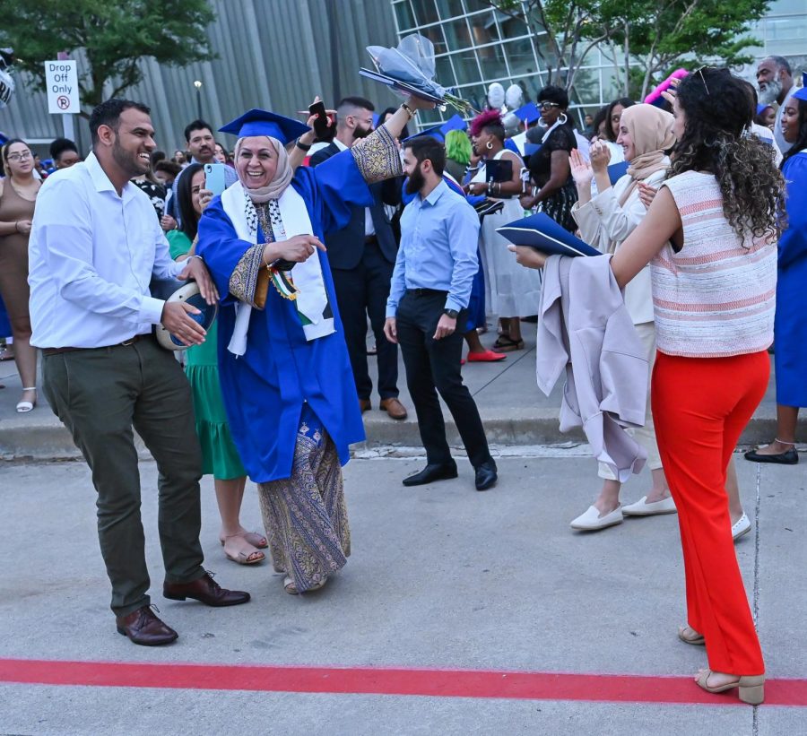 Nawal Albanna (55, Associates of Business) celebrates with her family outside the Curtis Culwell Center. 