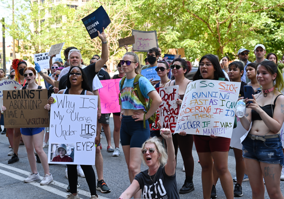 Protesters at the  Rising Together rally express their support for abortion access after the overturning of Roe v. Wade by the Supreme Court.