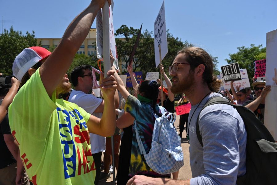 Cody Johnson, an abortion-rights protester, faces off with an anti-abortion protester at the Dallas Rally for Abortion Justice.