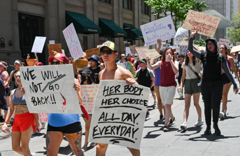 Abortion rights protesters march through the streets of downtown Dallas to protest the overturning of Roe v. Wade.