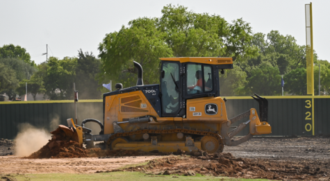 A bulldozer removes dirt from the Eastfield Baseball field during construction on July 22.