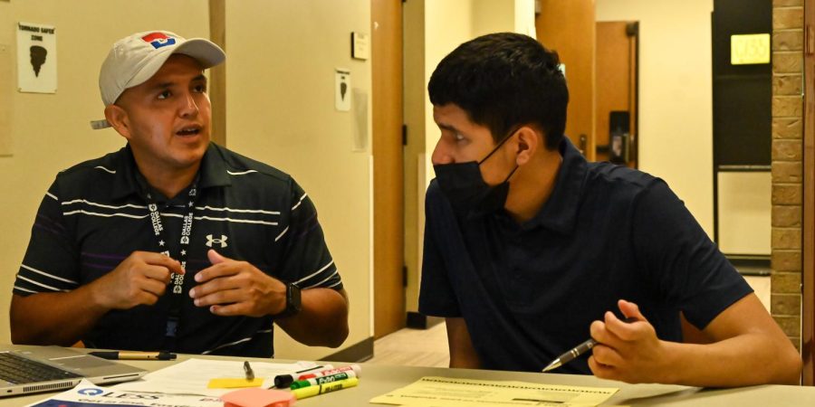 Student success coach Erbin Ayala sits and talks with Christopher Tellez in the Hive on Aug. 1. Ayala uses his experience as an Eastfield alumnus to coach students.