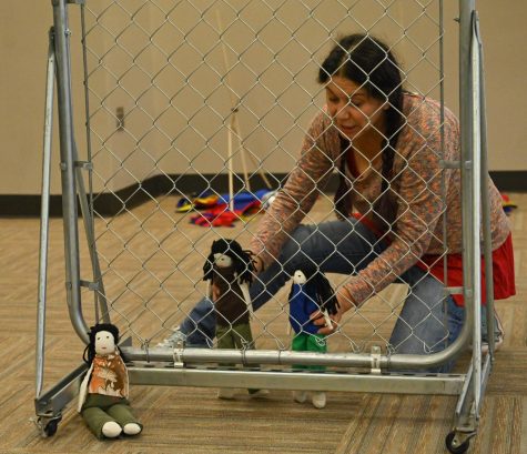 Frida Espinosa Muller performs in Ursula at Dallas College on Sept. 28, with dolls to convey the struggles that migrant children go through when placed in a detention center.