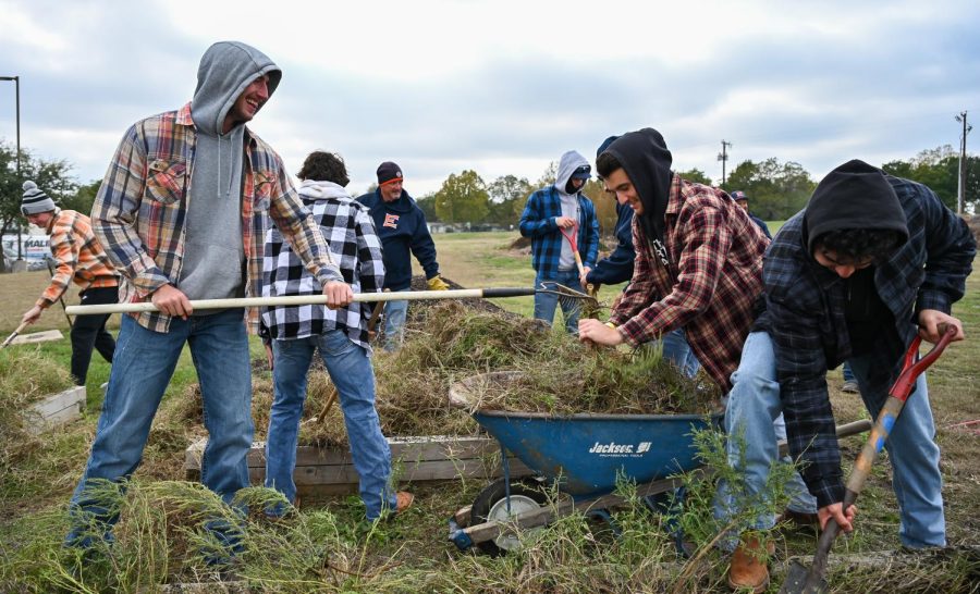 The Eastfield Harvester Bees baseball team helps clean out Eastfields community garden on Nov. 15.
