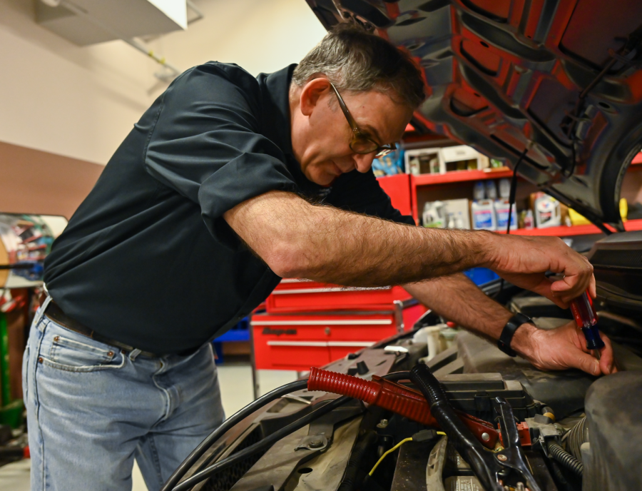Peter Lamborghini works on the engine of a van inside the garage of the T building on Nov. 29.