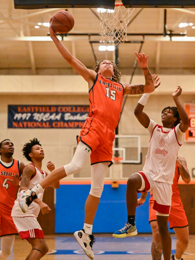 Torian Harris leaps away from Dallas Premier Prep players to score for Eastfield.