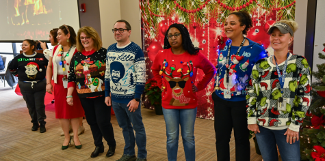 Eastfield faculty members line up for the ugly sweater competition during the Holiday Luncheon.