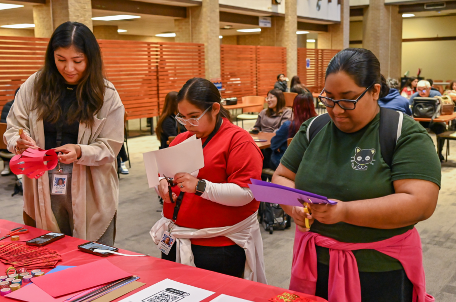 Melissa Rodriguez, Alondra Martinez and Itzel Sanchez make red envelopes for friends and family on Jan. 23 in The Hive.