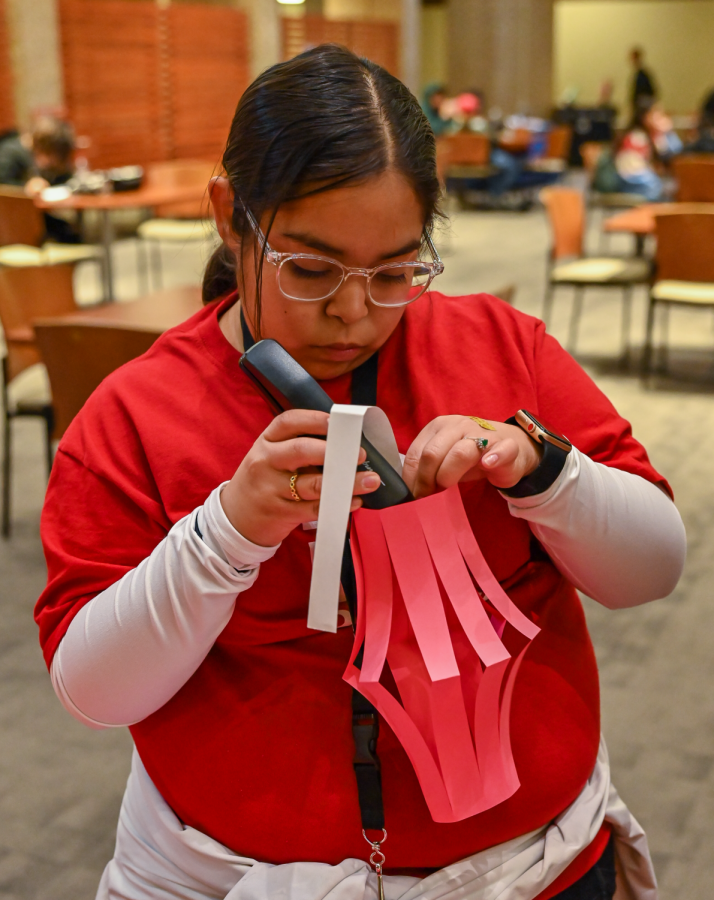 Melissa Rodriguez staples a handle to her envelope for the Lunar New Year.