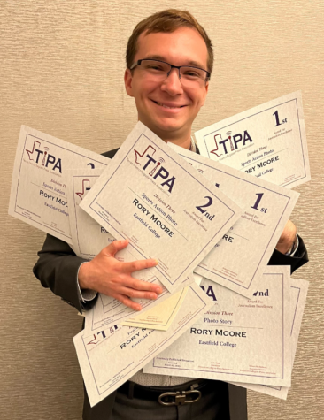 Rory Moore holding a bunch of awards