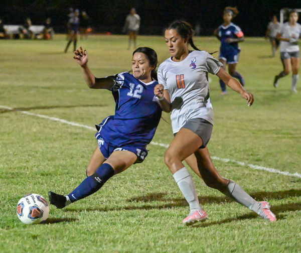 Reyna Vargas dashes to take the ball from Crystal Gonzalez.