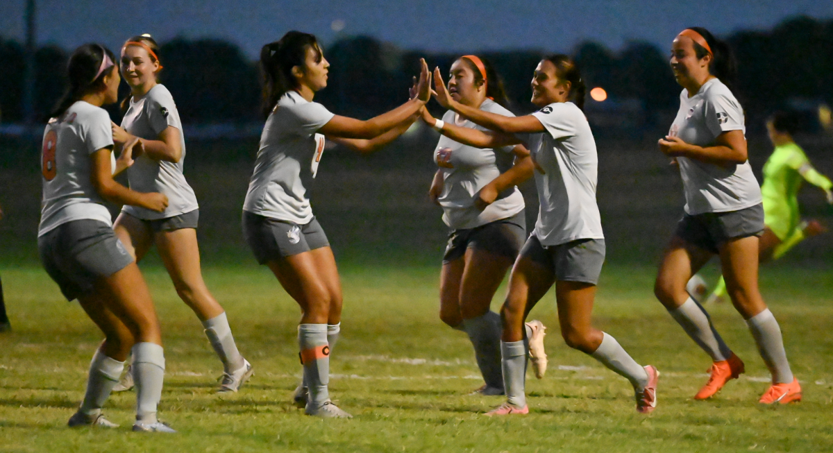 Midfielder+Reyna+Vargas+celebrates+with+her+teammates+after+scoring+a+goal.