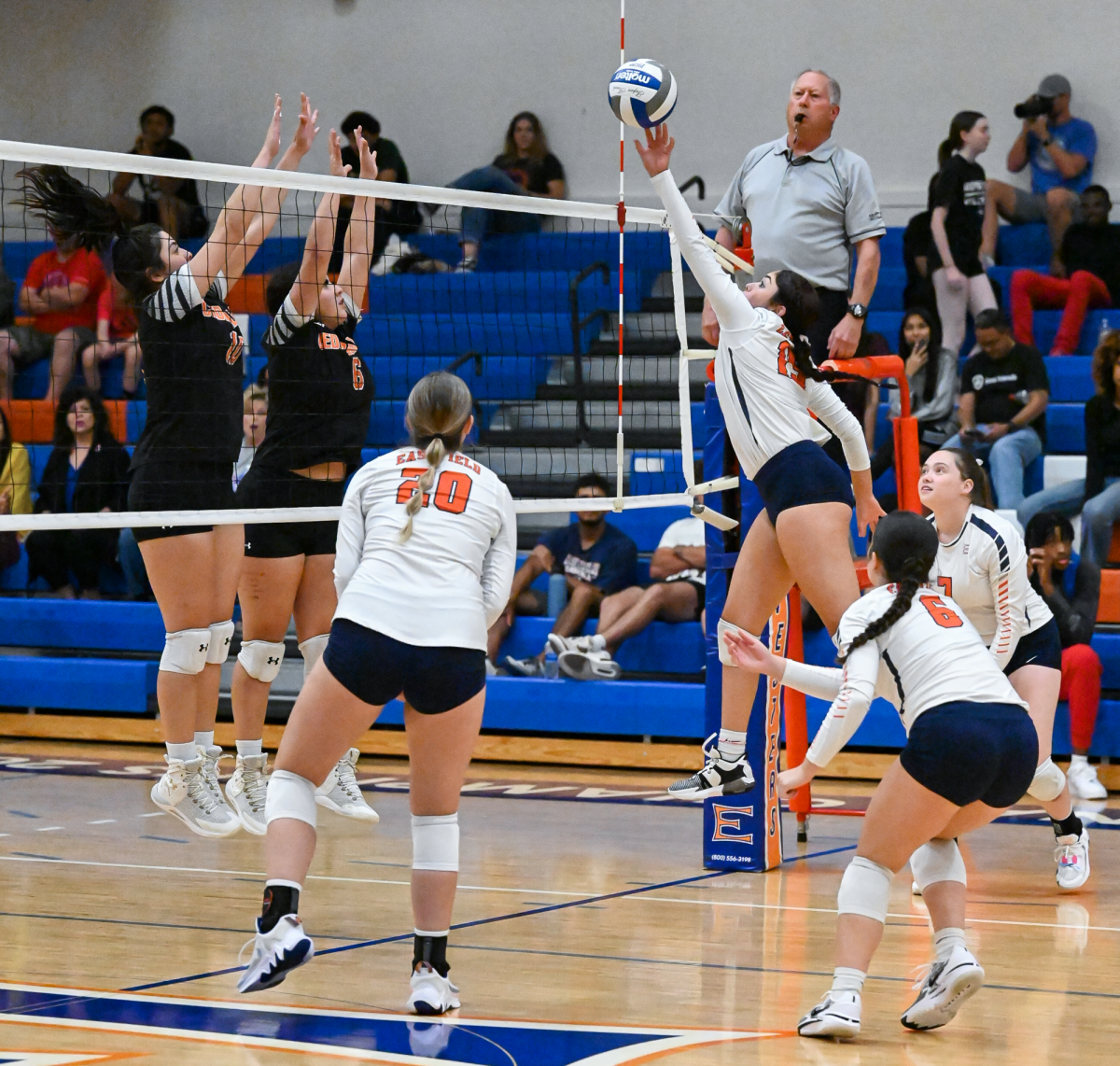 Right side hitter Leslie Torres reaches to block a strike from Cedar Valley with assistance from McKenzie Anderson and McKayla Archer.