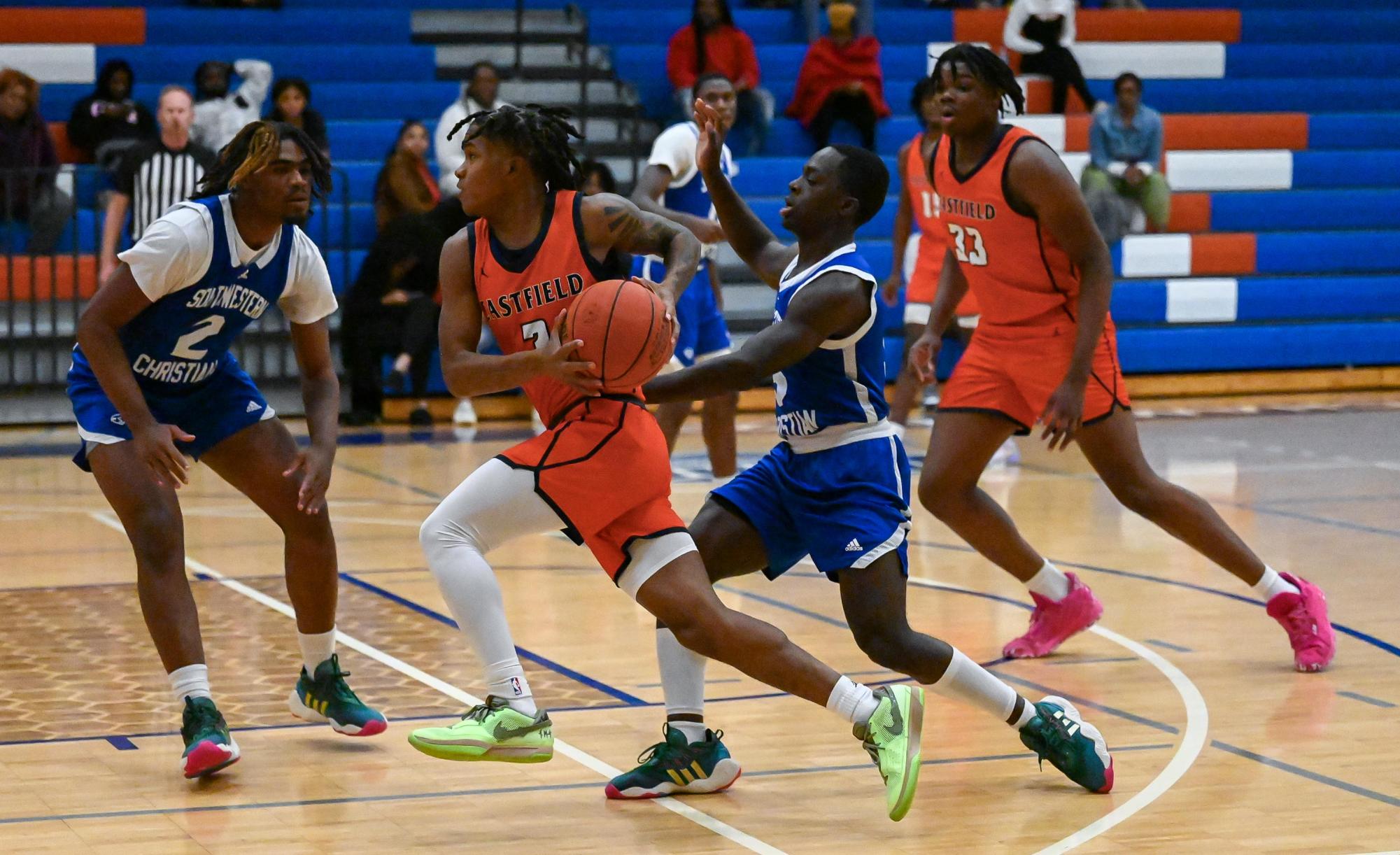 Marcus Gill, Jr. runs through defense from Zelt Minor and Kameron Hunter.